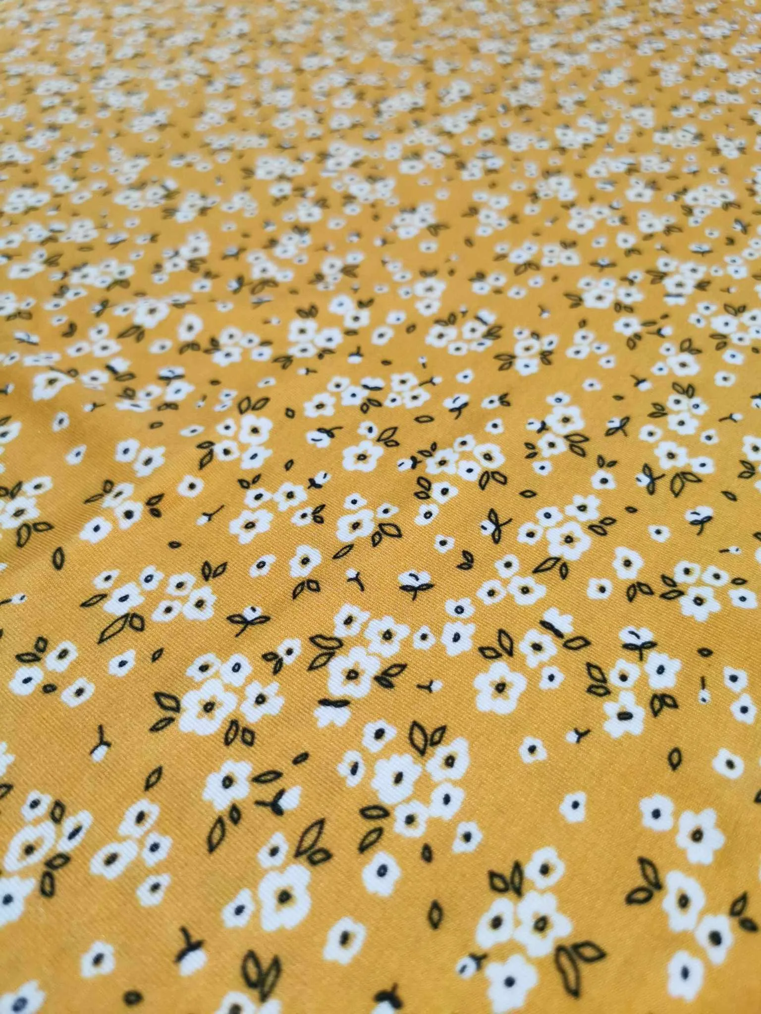 Yellow Ditsy Floral design on stretch super soft bamboo lycra jersey fabric for sewing your own clothes.