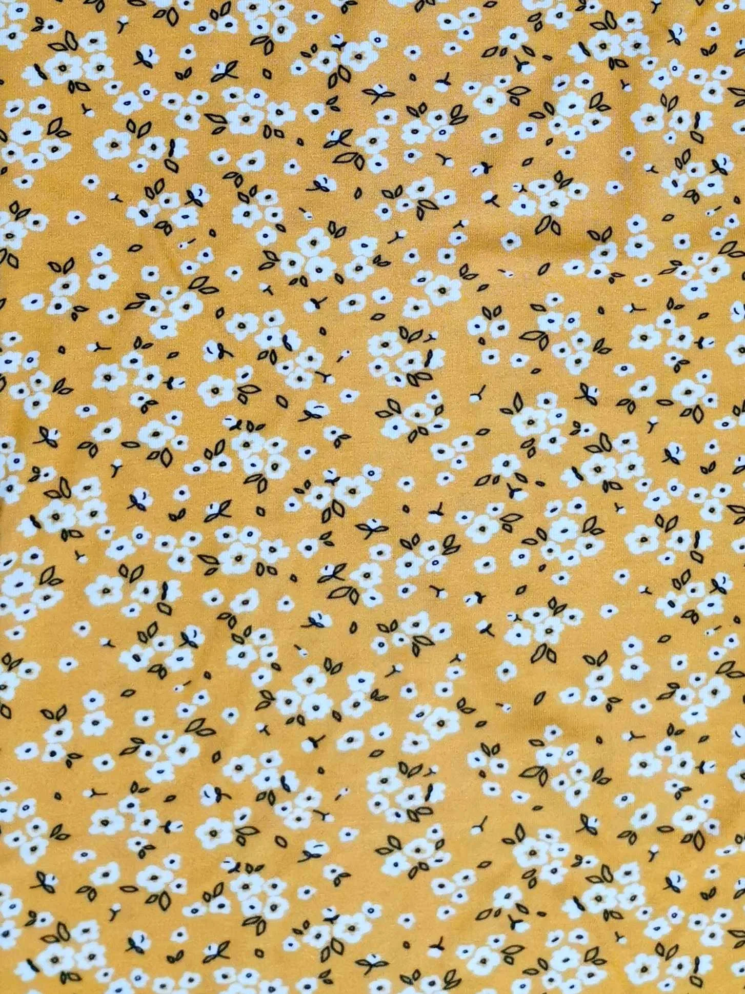 Yellow Ditsy Floral design on stretch super soft bamboo lycra jersey fabric for sewing your own clothes.