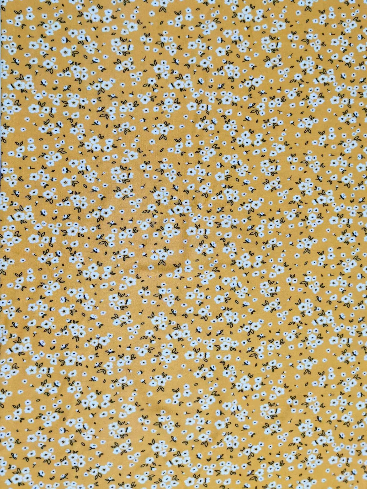 Yellow Ditsy Floral design on stretch super soft bamboo lycra jersey fabric for sewing your own clothes.