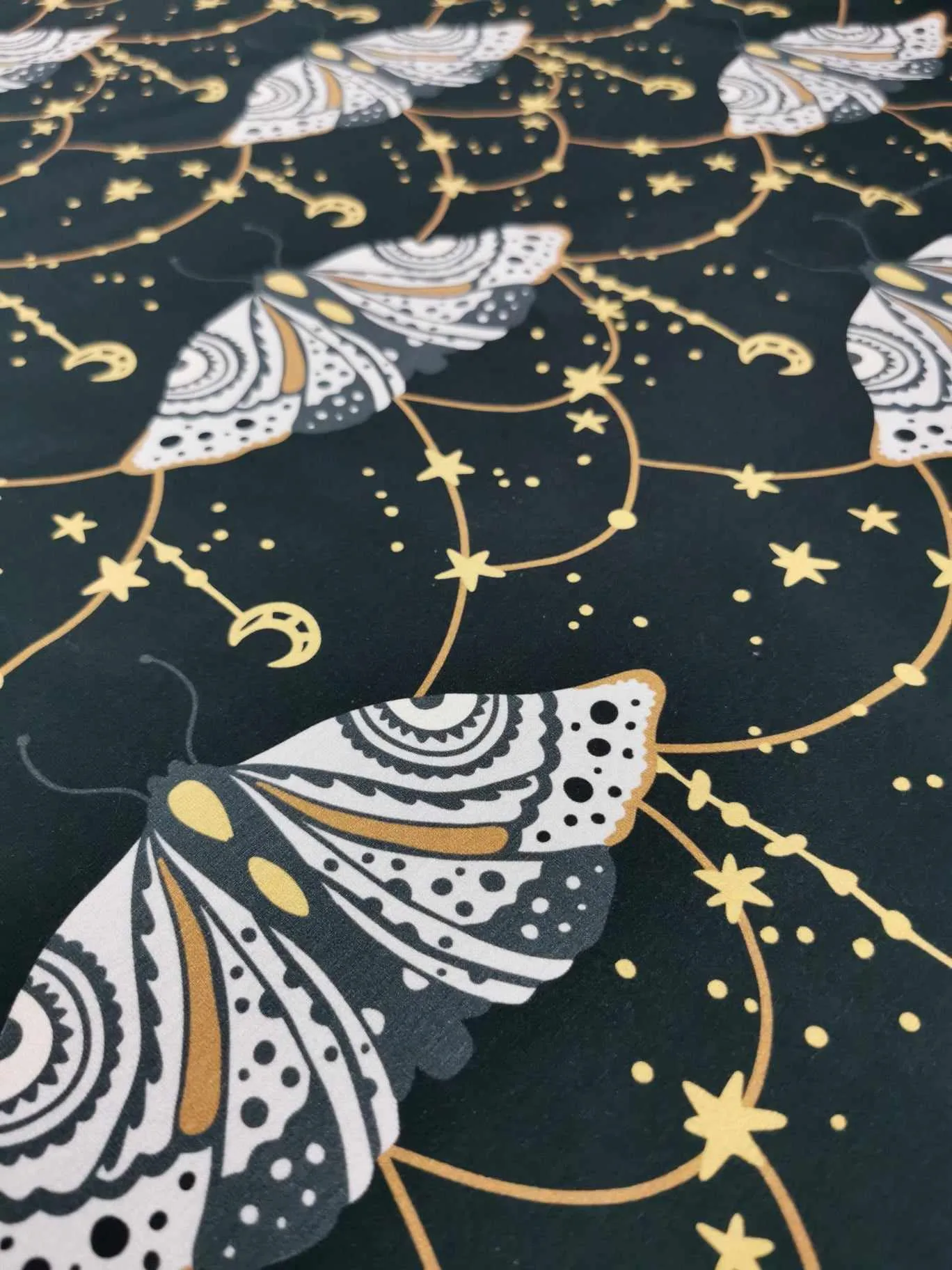 Dark grey witchy moth with moons and stars cotton lycra jersey stretch fabric
