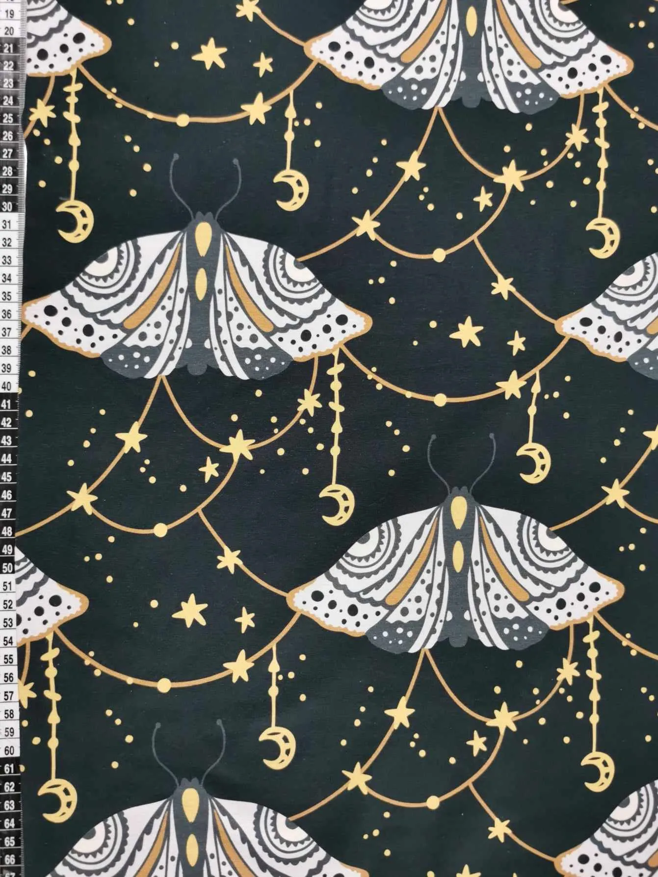 Dark grey witchy moth with moons and stars cotton lycra jersey stretch fabric