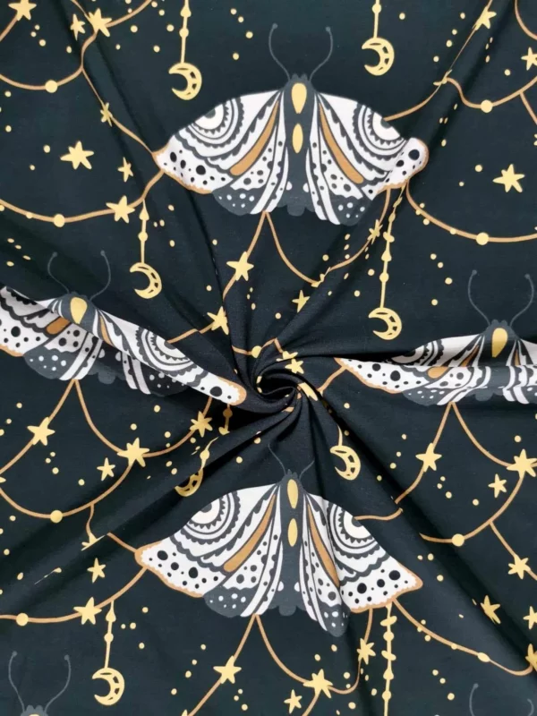 Dark grey witchy moth with moons and stars cotton lycra jersey stretch fabric