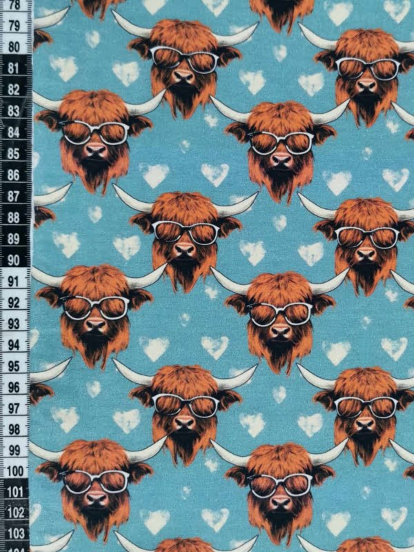 Highland cows on a light blue background with white love hearts, jersey fabric with 4 way stretch