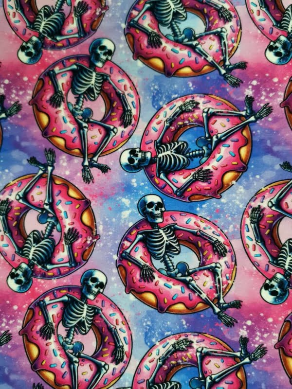 Fun pink skeletons in floating donuts on purple galaxy base, jersey fabric with 4 way stretch