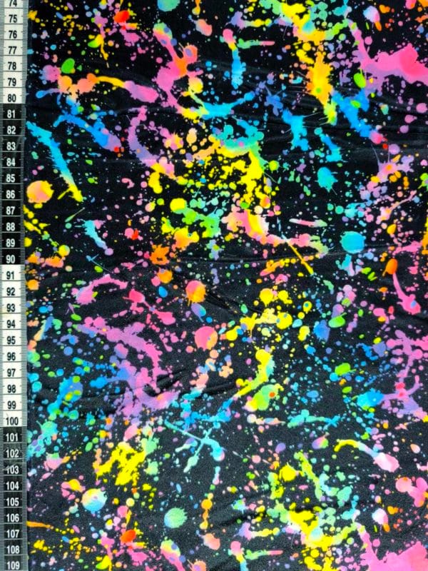 vibrant rainbow Paint splatter design on super soft squish fabric, a stretchy snuggly polyester material.