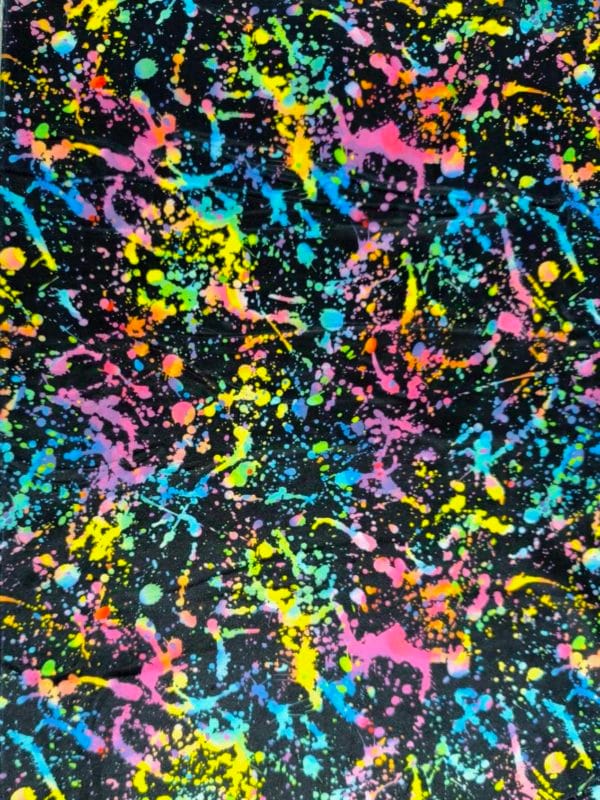 vibrant rainbow Paint splatter design on super soft squish fabric, a stretchy snuggly polyester material.