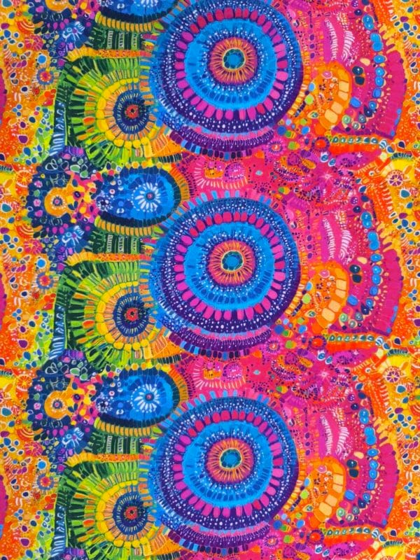 Stunning vibrant mandala design with blue circles and pink features on beautiful quality stretch jersey fabric, perfect for sewing your own clothes.