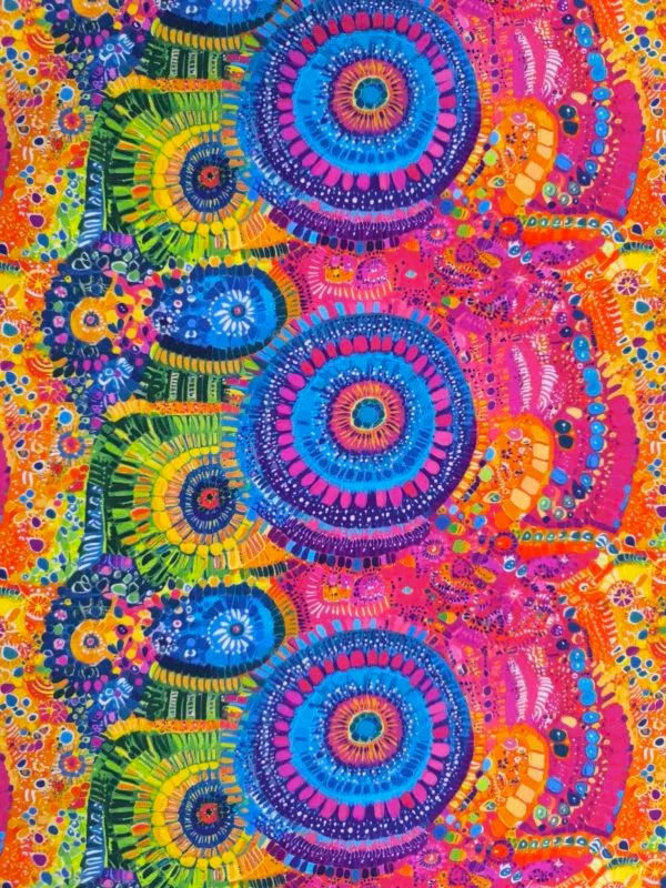 Stunning vibrant mandala design with blue circles and pink features on beautiful quality stretch jersey fabric, perfect for sewing your own clothes.