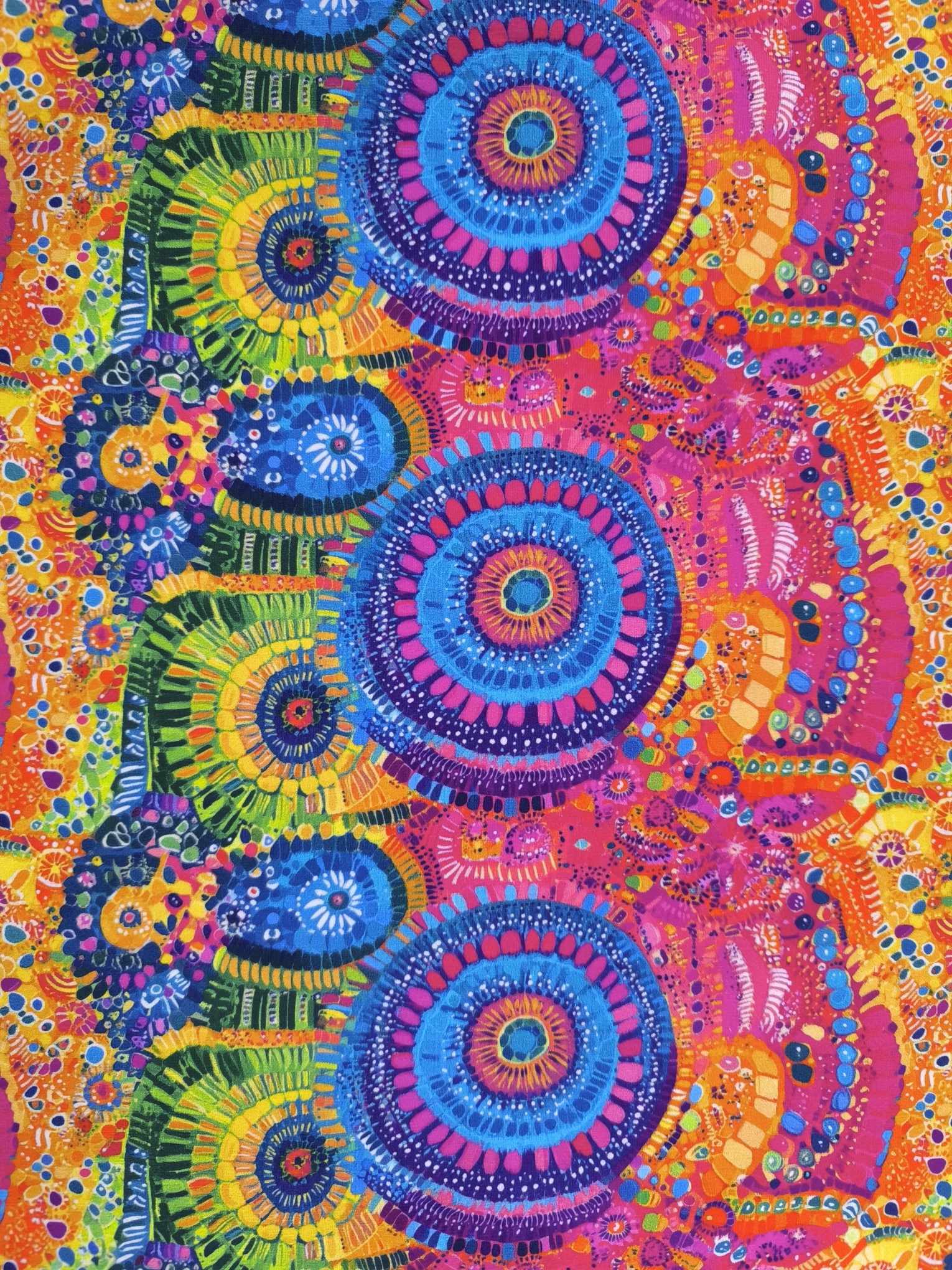 Stunning vibrant mandala design with blue circles and pink features on beautiful quality stretch jersey fabric, perfect for sewing your own clothes.