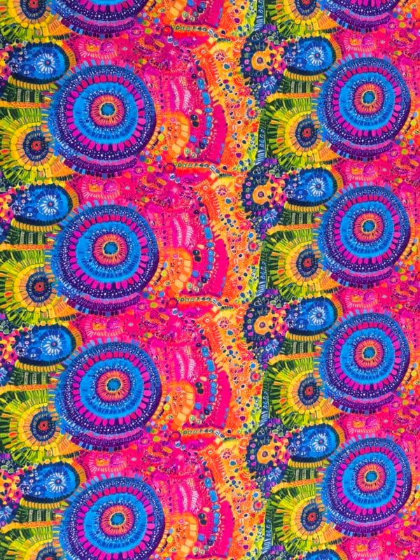 Stunning vibrant mandala design with blue circles and pink features on beautiful quality stretch jersey fabric, perfect for sewing your own clothes.