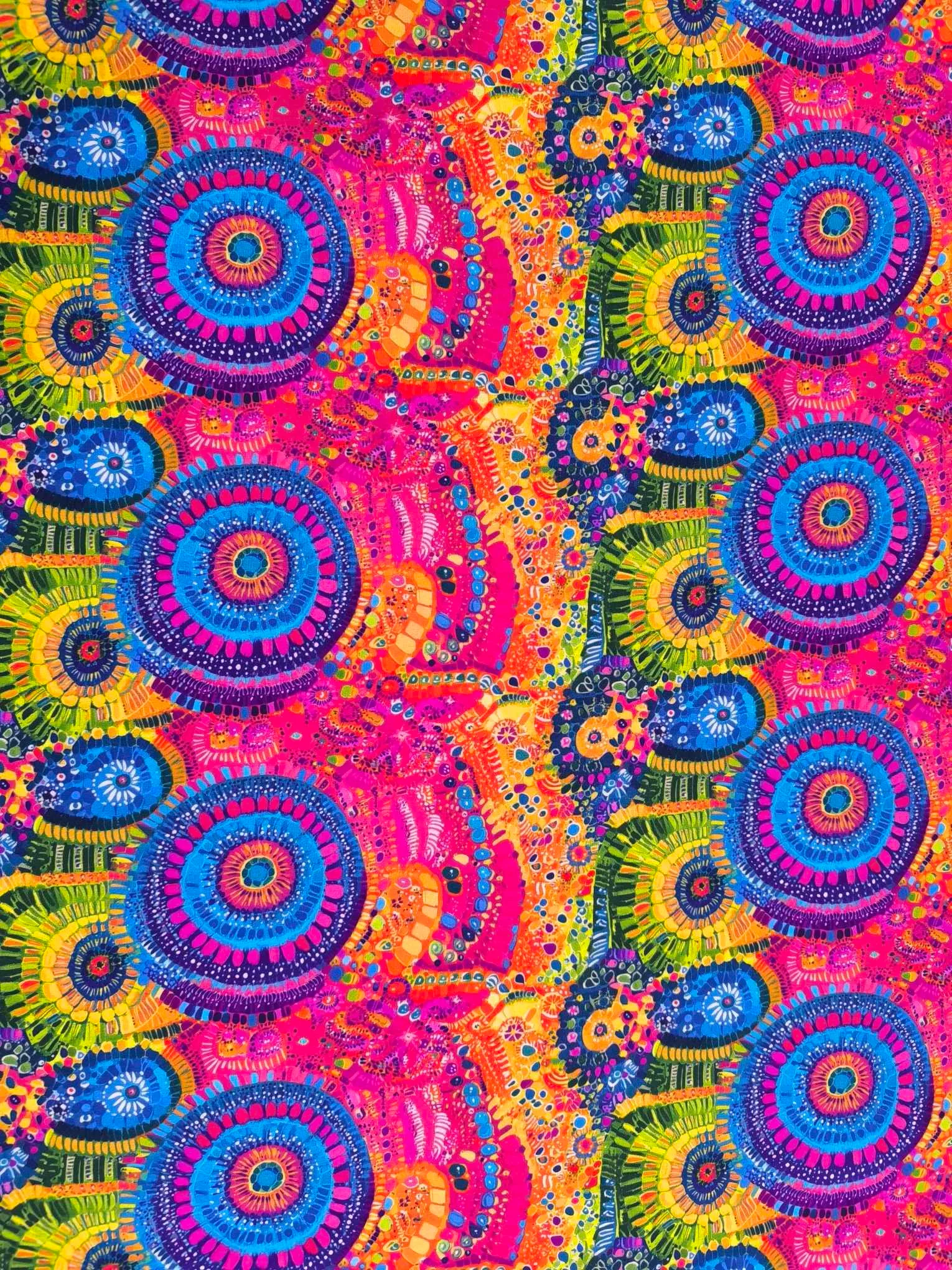 Stunning vibrant mandala design with blue circles and pink features on beautiful quality stretch jersey fabric, perfect for sewing your own clothes.