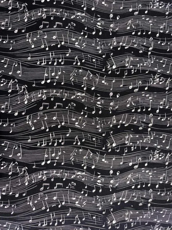 monochrome black and white musical notes dancing across a black background on beautiful quality stretch jersey fabric, perfect for sewing your own clothes.