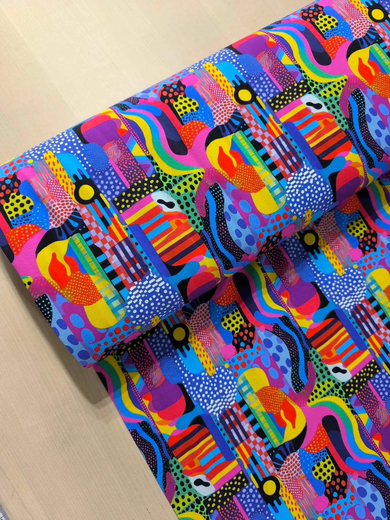 Colourful abstract shapes and dot design on a jersey stretch fabric base, beautifully soft and stretchy material.
