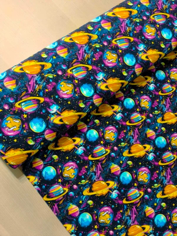 Funky cool planet designs on a dark blue background with purple elements. Jersey stretch fabric base, beautifully soft and stretchy material.