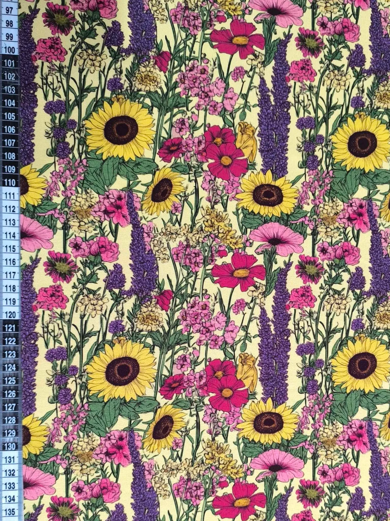 Sunflower and lavendar flowers on a pretty pale yellow base. Jersey stretch fabric base, beautifully soft and stretchy material.