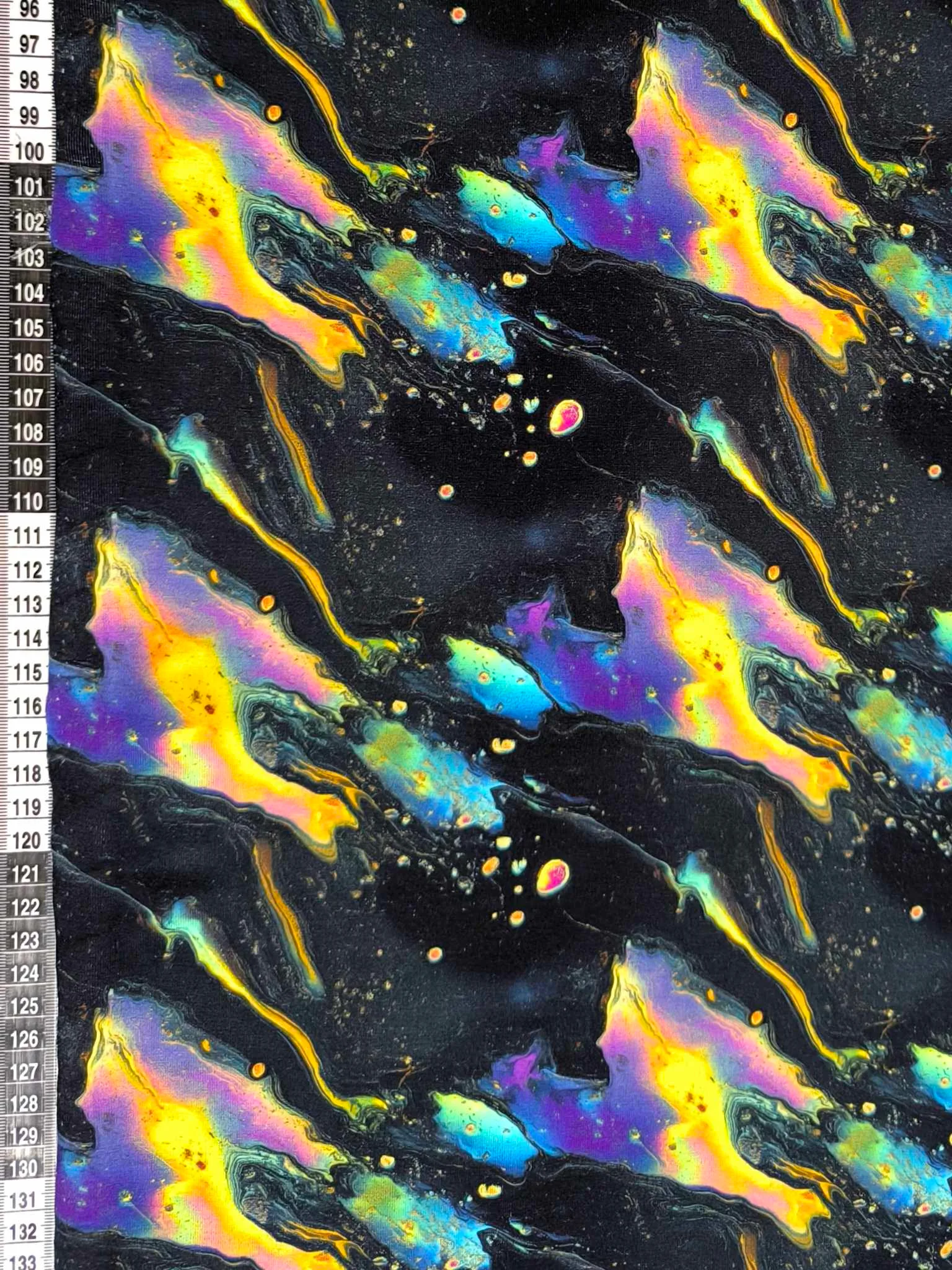 Black oil slick design on a jersey stretch fabric base, beautifully soft and stretchy material.