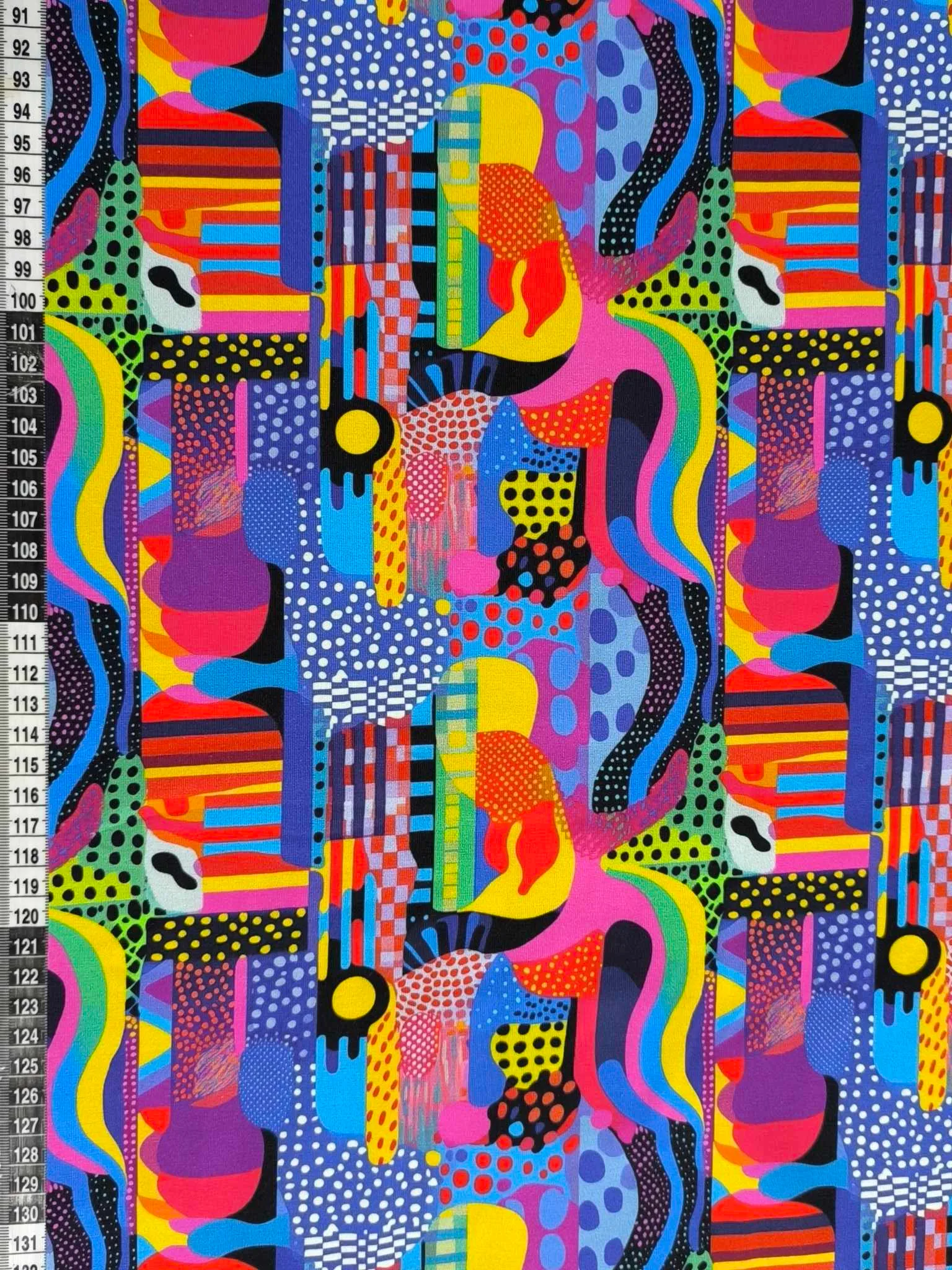 Colourful abstract shapes and dot design on a jersey stretch fabric base, beautifully soft and stretchy material.