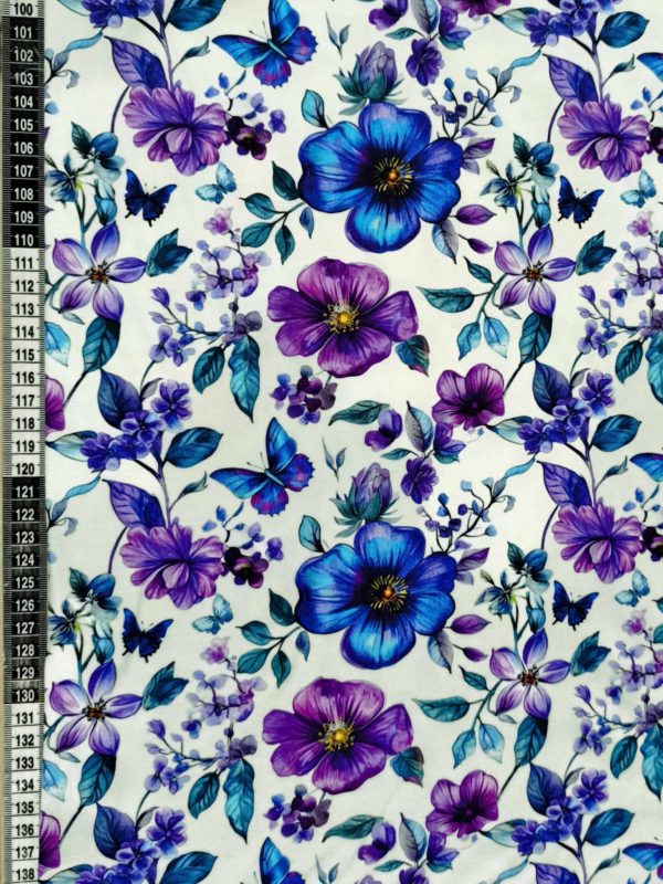 Blue and purple petals and florals, with butterflies on a white background. Jersey stretch fabric base, beautifully soft and stretchy material.